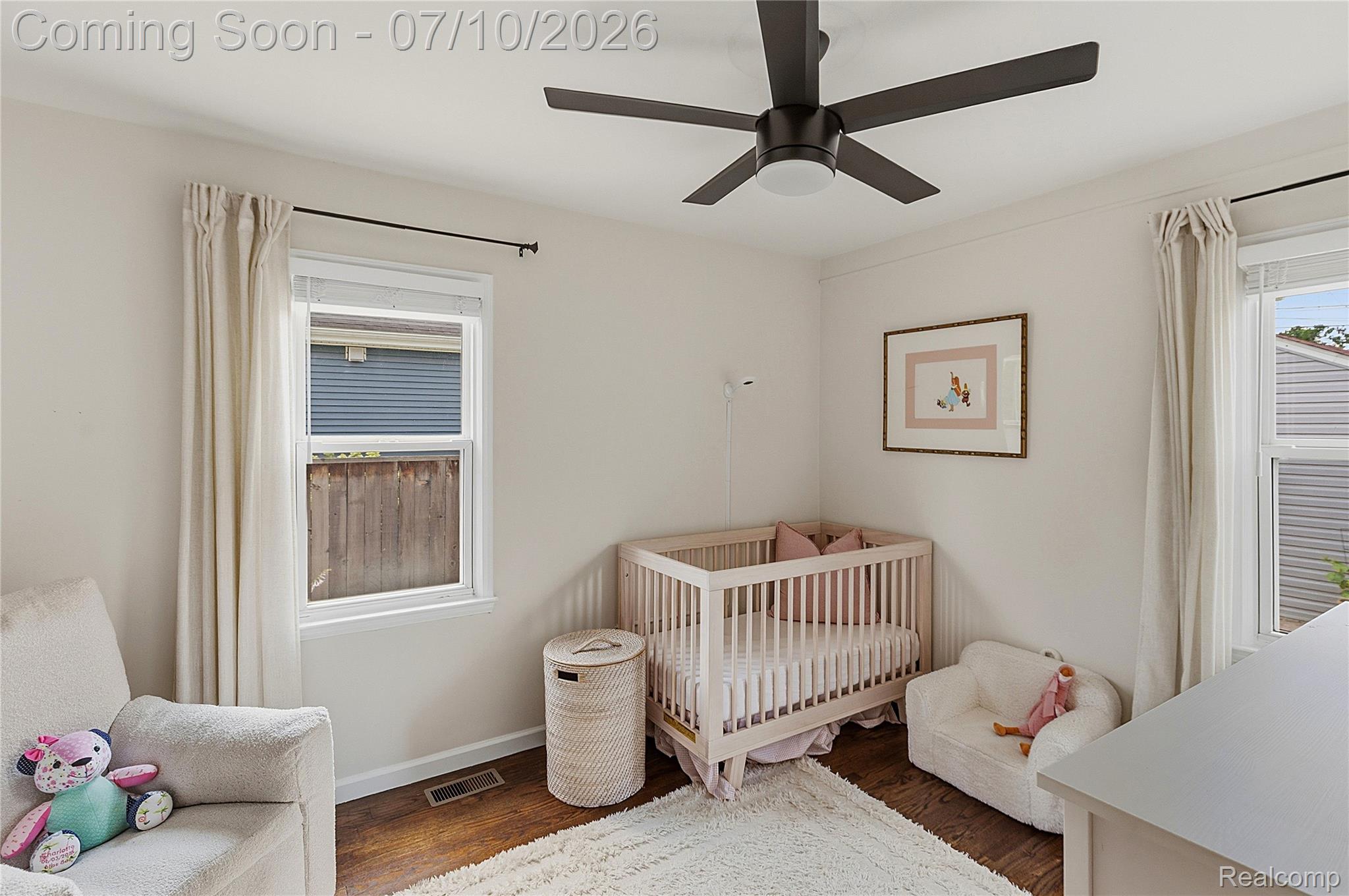 3295 Cumberland Road Berkley, MI 48072 - Photo 15 of 32 Interior room featuring hardwood flooring, white walls, two windows with blinds, a ceiling fan with integrated lighting, and crown molding