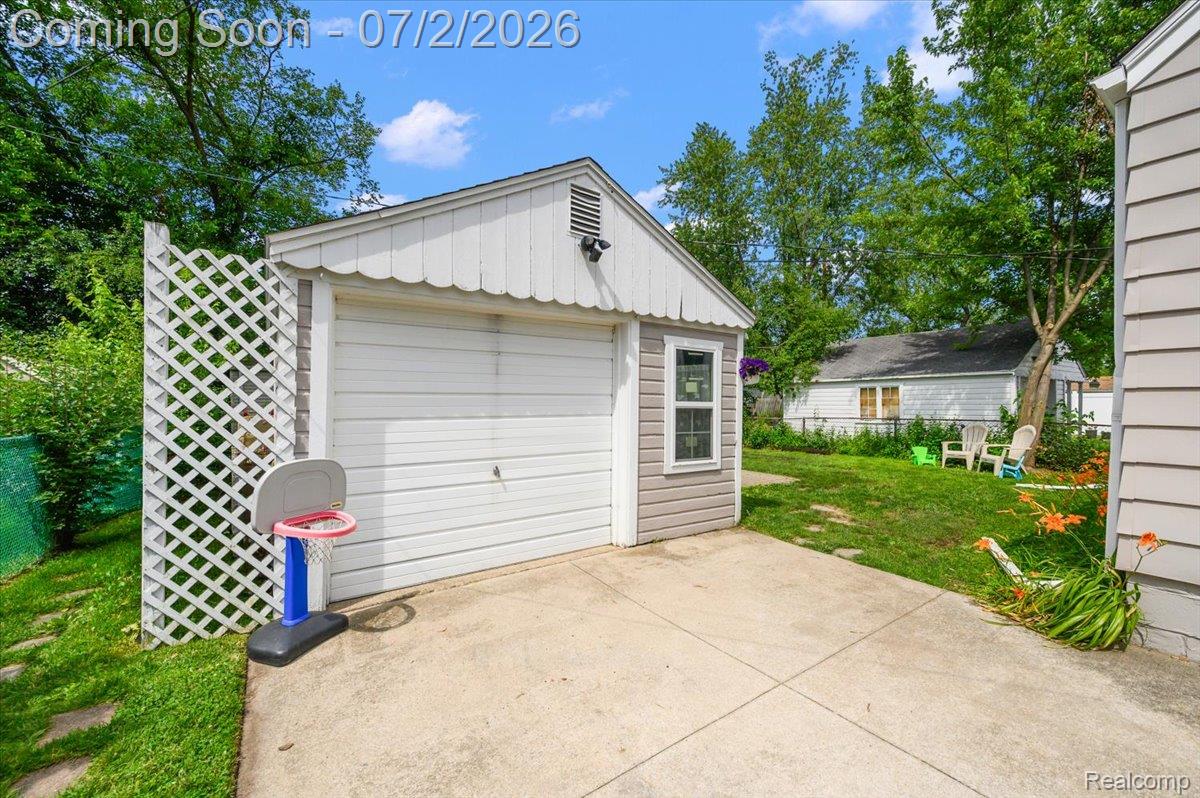 1706 Princeton Road Berkley, MI 48072 - Photo 45 of 49 Detached garage featuring a white overhead door, siding exterior, and a side window