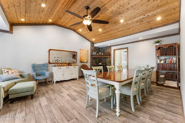 a dining room with furniture and wooden floor