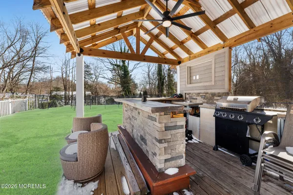 a view of a patio with a table and chairs under an umbrella