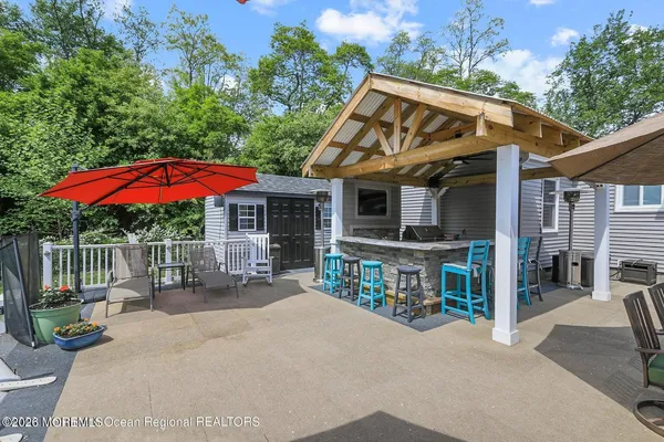 a view of a house with patio and sitting area