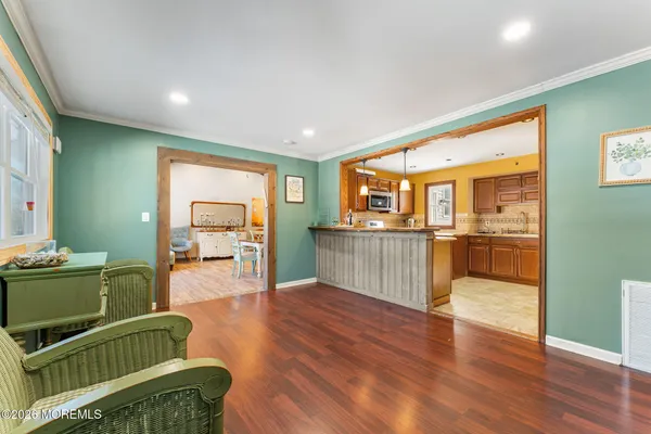 a kitchen with stainless steel appliances kitchen island granite countertop a refrigerator and a stove top oven