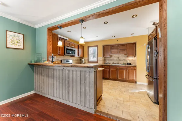 a kitchen with stainless steel appliances granite countertop a refrigerator and a sink
