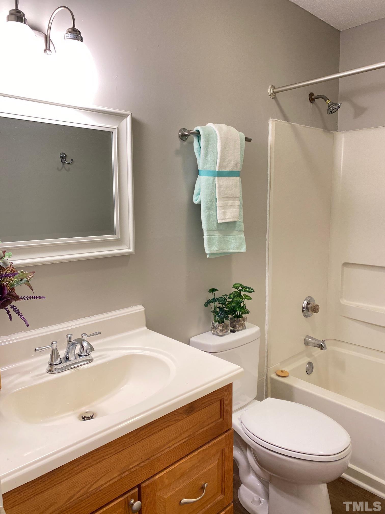 4232 Kaplan Drive Raleigh, NC 27606 - Photo 19 of 21 a bathroom with a sink a toilet and shower
