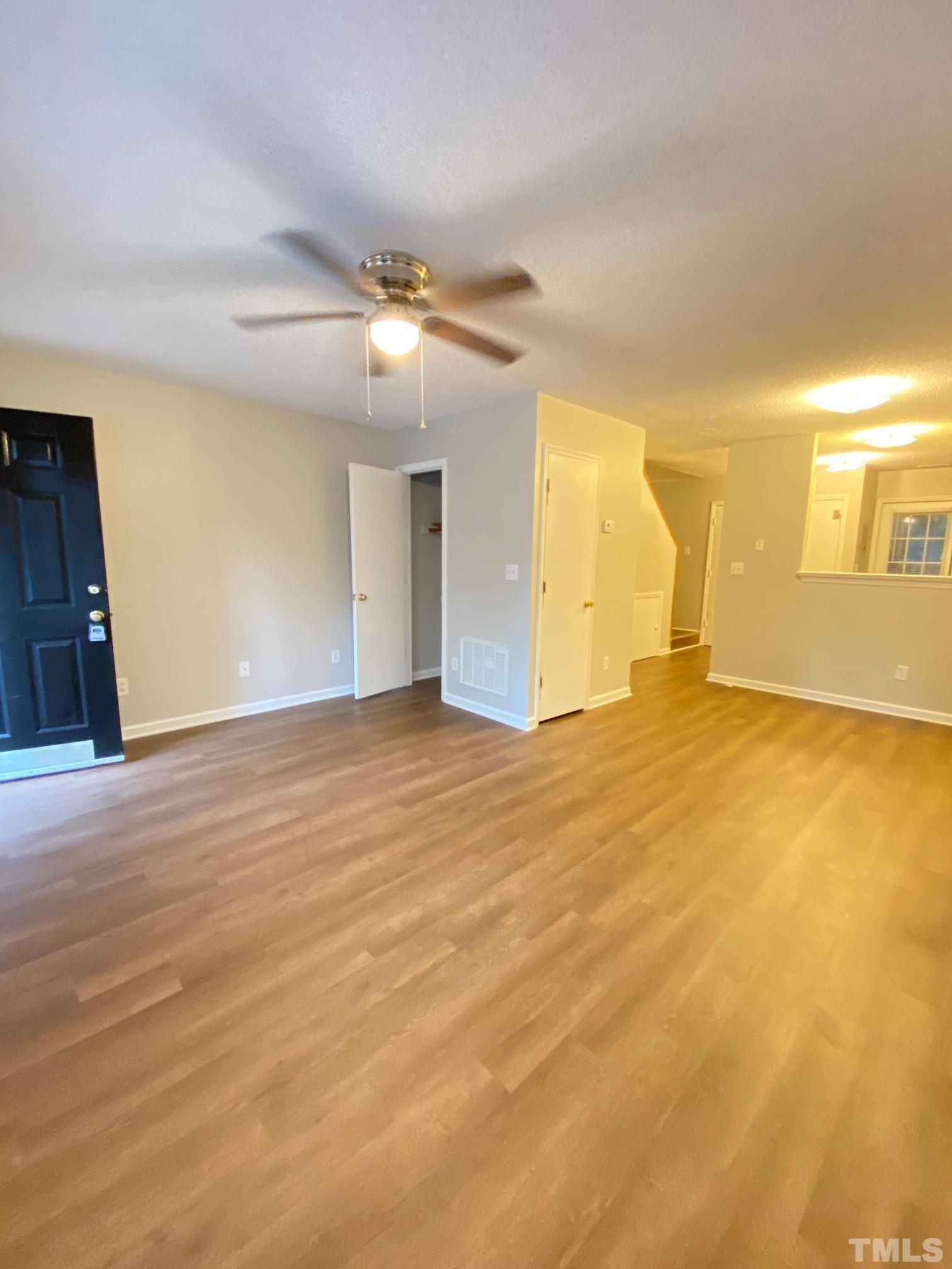 4232 Kaplan Drive Raleigh, NC 27606 - Photo 6 of 21 a view of an empty room with window and a kitchen
