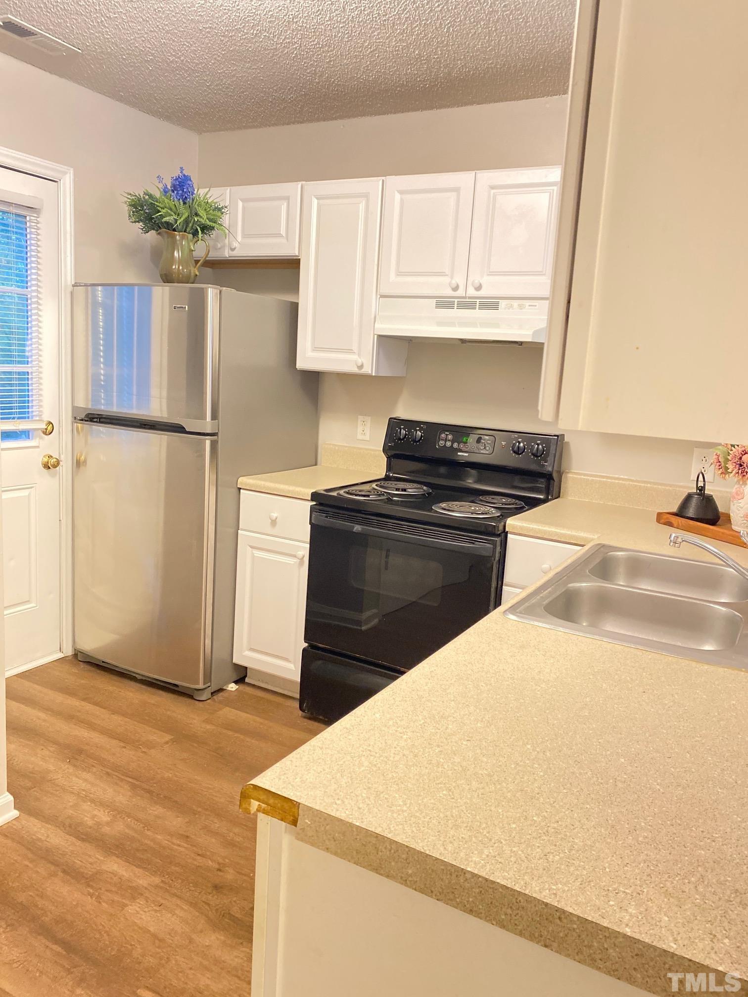 4232 Kaplan Drive Raleigh, NC 27606 - Photo 9 of 21 a kitchen with granite countertop a sink stainless steel appliances and cabinets