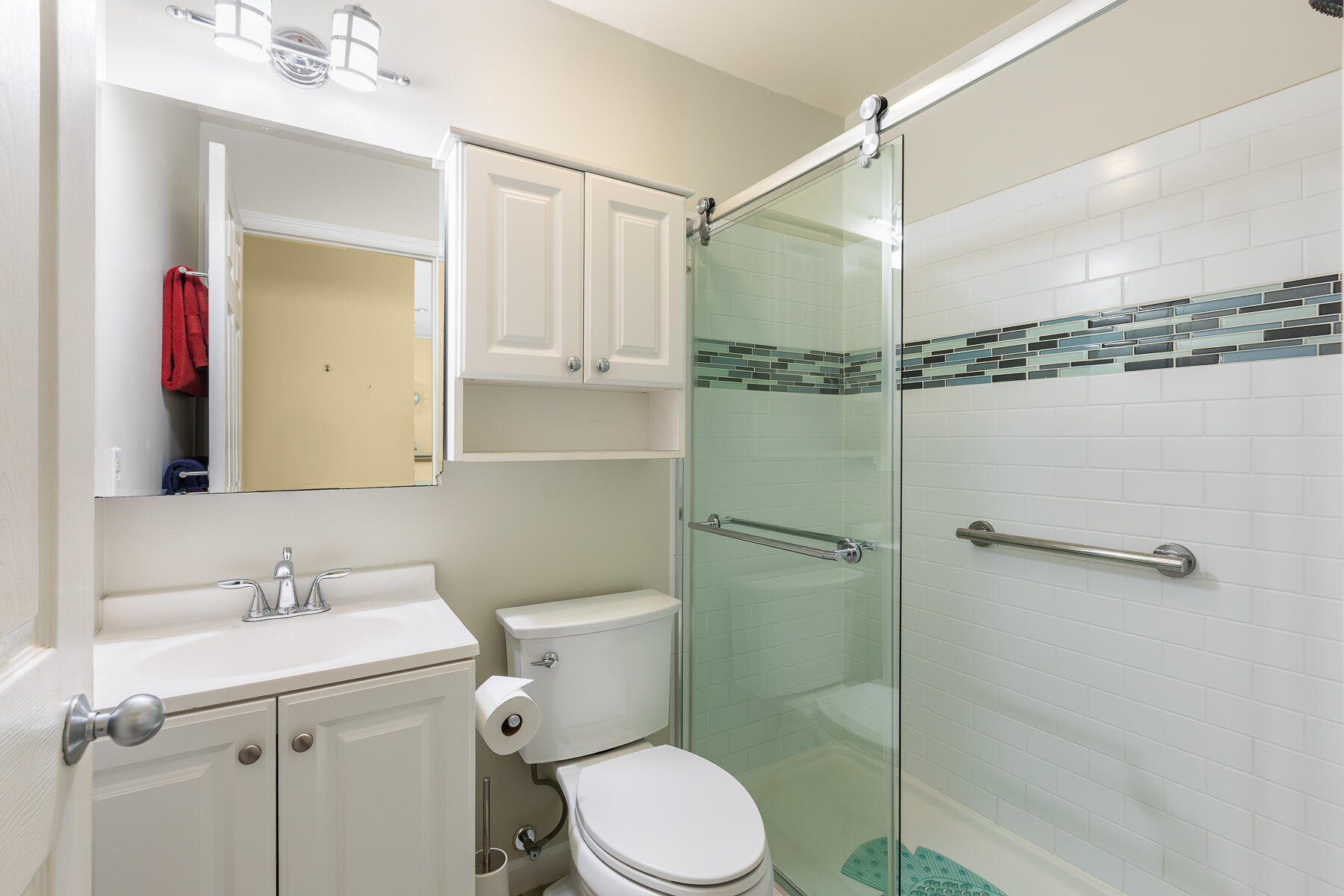 620 Thomas Street, Unit 175 Key West, FL 33040 - Photo 22 of 30 a bathroom with a shower sink vanity mirror and toilet