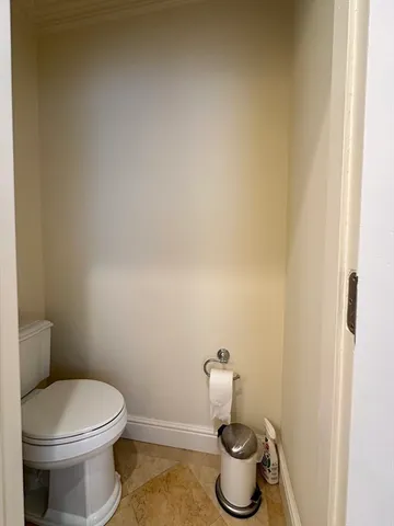 a white toilet sitting next to a bathroom sink