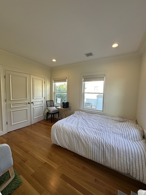 191 Newtonville Avenue, Unit 191 Newton, MA 02458 - Photo 21 of 41 a spacious bedroom with a bed and wooden floor