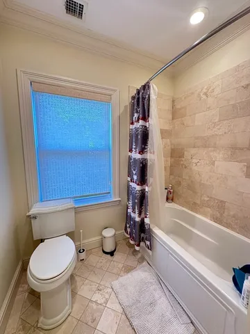 a bathroom with a toilet a sink and bathtub
