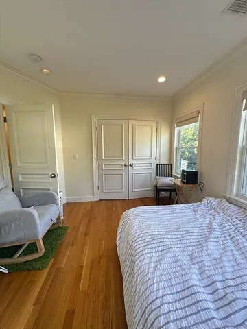 a bedroom with a bed and dresser