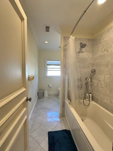 a bathroom with a bathtub and a shower