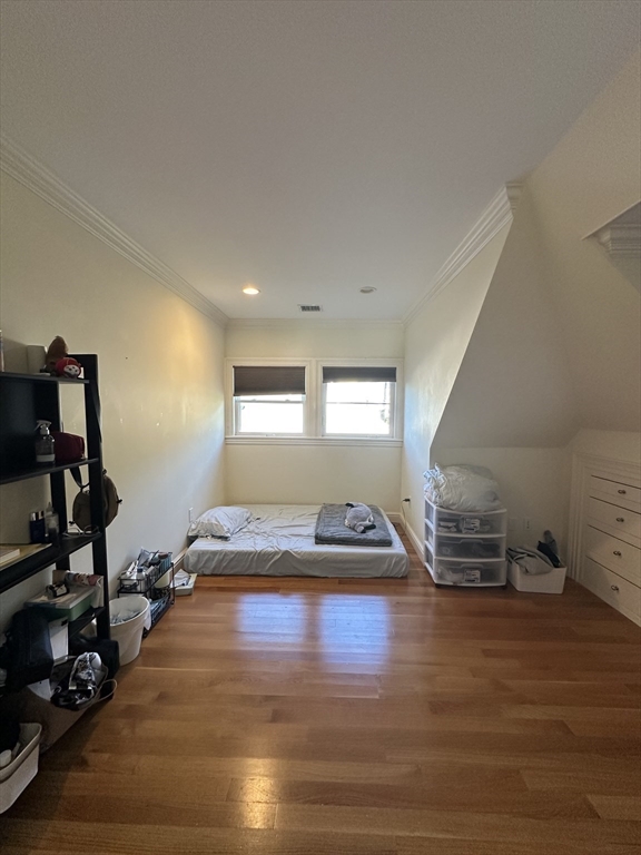 191 Newtonville Avenue, Unit 191 Newton, MA 02458 - Photo 32 of 41 a bedroom with a bed and wooden floor