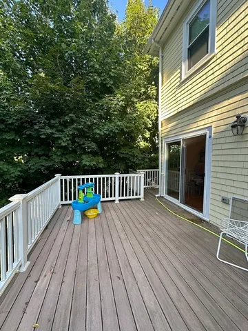 a balcony with wooden floor and outdoor space