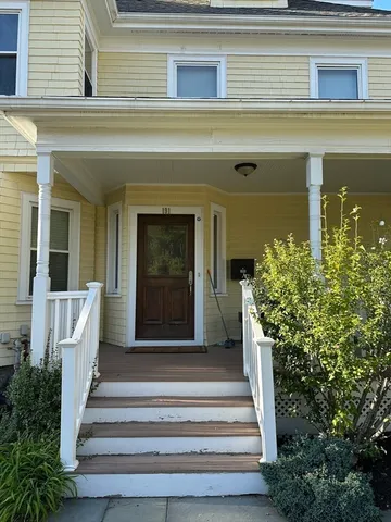 a front view of a house with potted plants