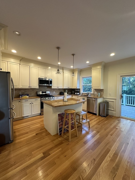 191 Newtonville Avenue, Unit 191 Newton, MA 02458 - Photo 7 of 41 a kitchen with a table chairs refrigerator and microwave