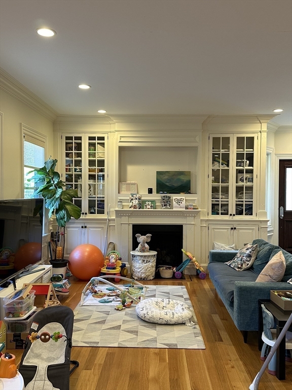 191 Newtonville Avenue, Unit 191 Newton, MA 02458 - Photo 8 of 41 a living room with furniture fireplace and a flat screen tv