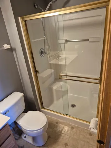 a bathroom with a sink toilet and shower