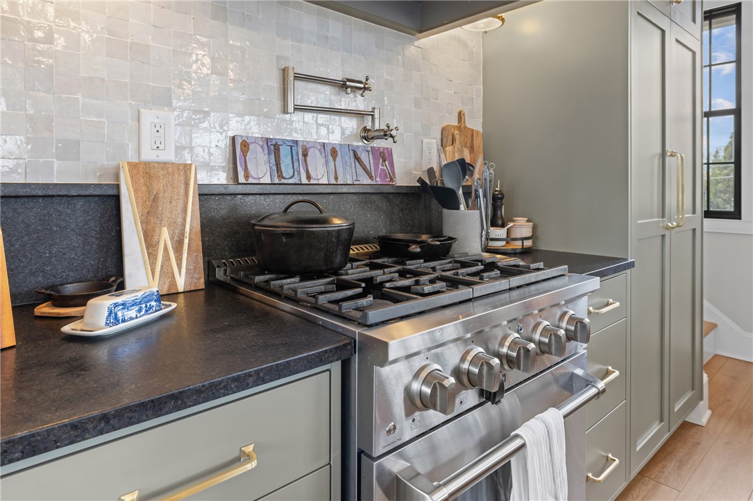 677 Lightwood Road Hartwell, GA 30643 - Photo 12 of 42 This modern kitchen features sleek countertops, stainless steel appliances, and ample cabinet storage.