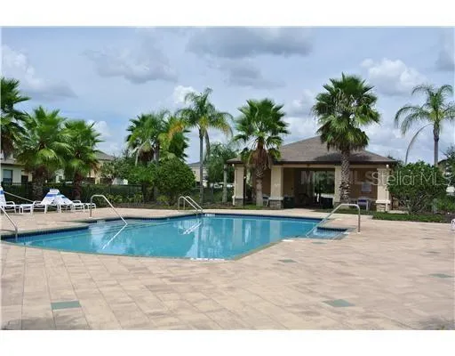 a view of a house with swimming pool and sitting area