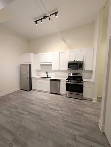 a kitchen with a sink stainless steel appliances and cabinets