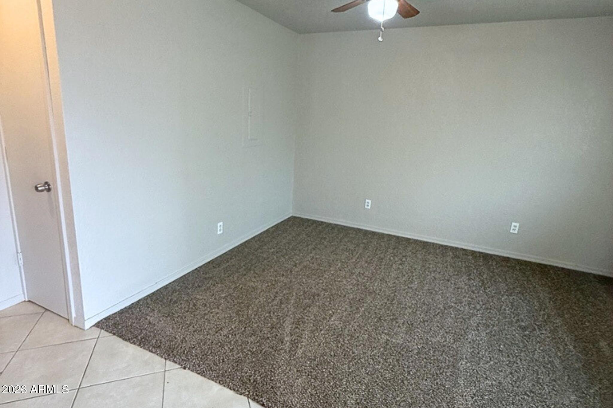 1702 West Shangri-la Road, Unit 2 Phoenix, AZ 85029 - Photo 3 of 10 an empty room with a ceiling fan and a window