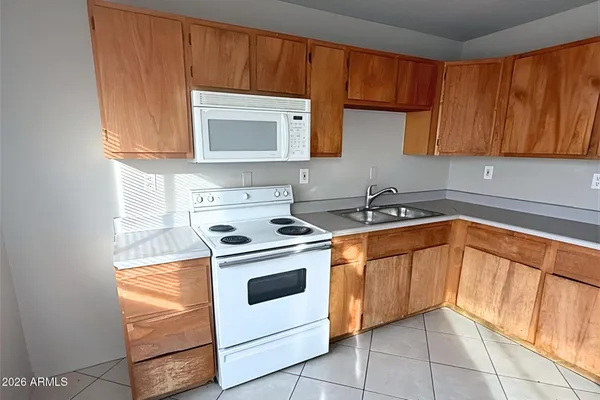 a kitchen with a stove sink and cabinets