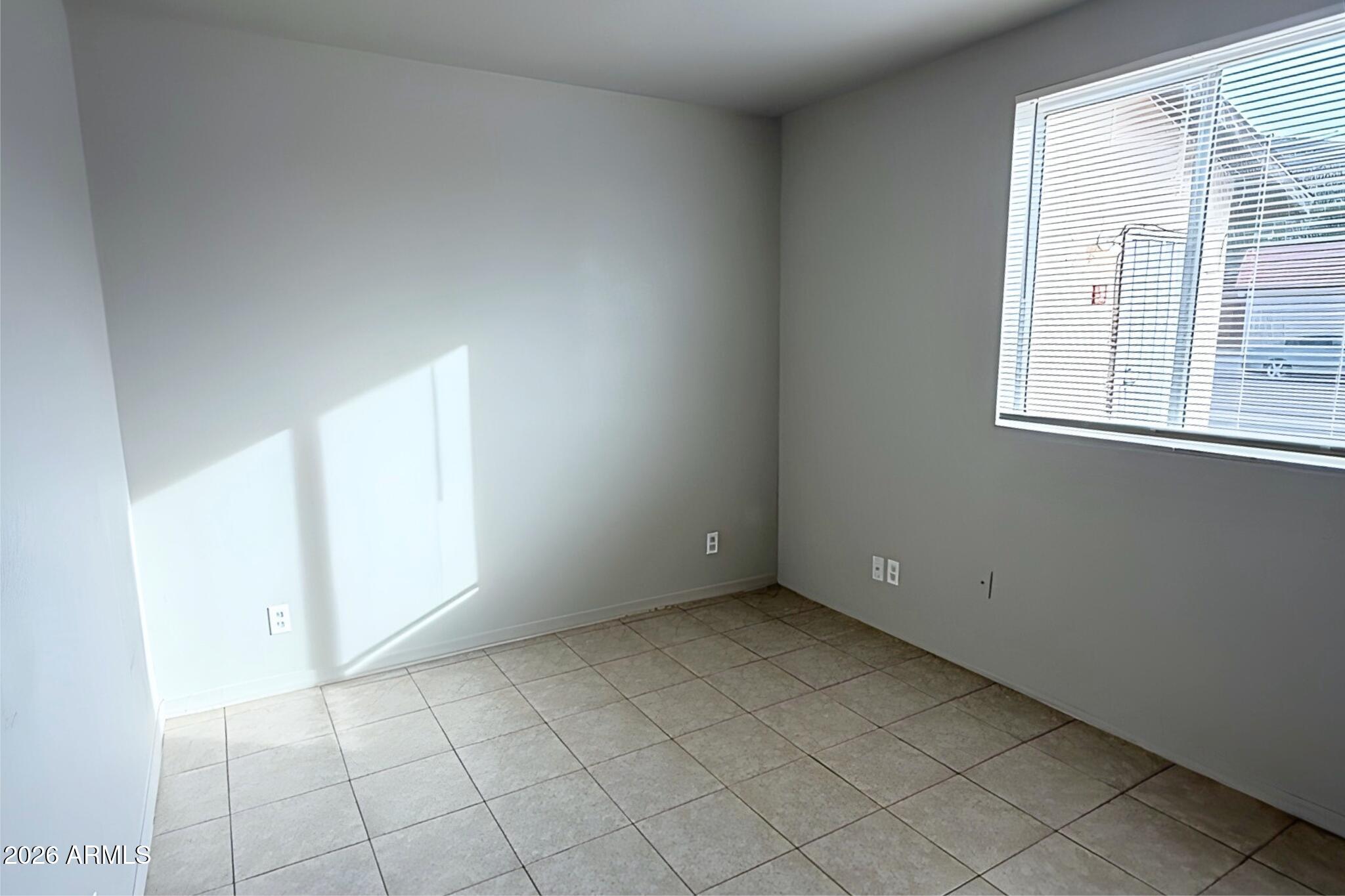 1702 West Shangri-la Road, Unit 2 Phoenix, AZ 85029 - Photo 7 of 10 an empty room with windows