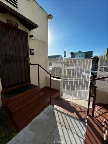 a view of a balcony with wooden floor and windows
