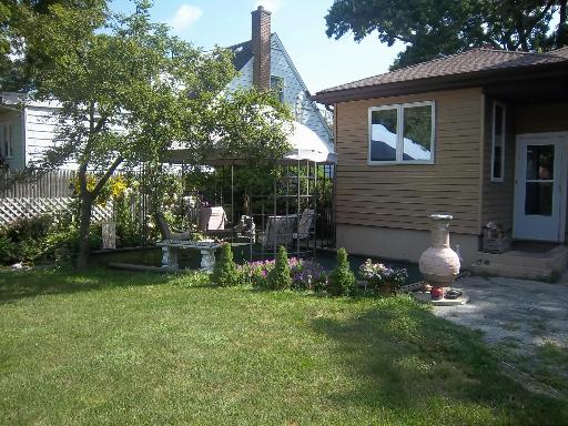 18328 Riegel Road Homewood, IL 60430 - Photo 12 of 14 a front view of a house with garden