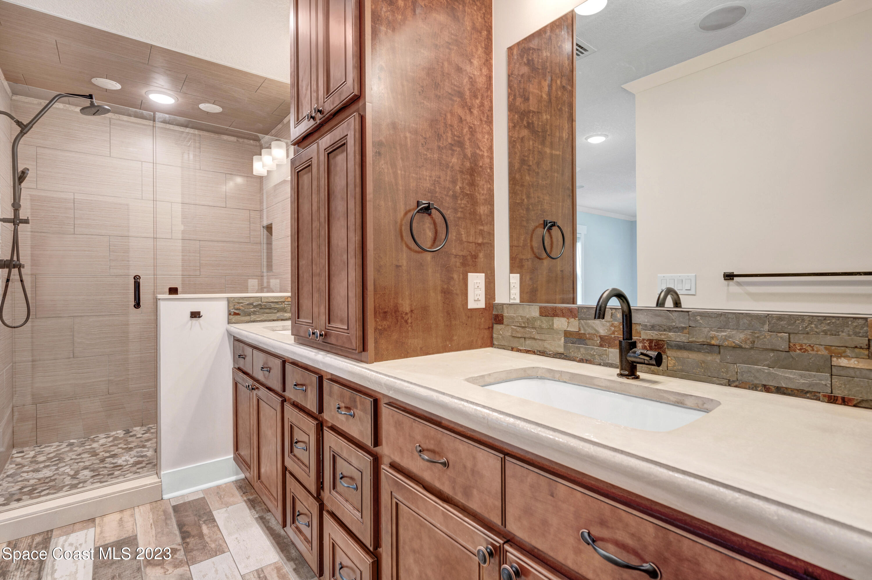 1720 Elizabeth Street Melbourne, FL 32901 - Photo 13 of 33 a bathroom with a double vanity sink mirror and shower
