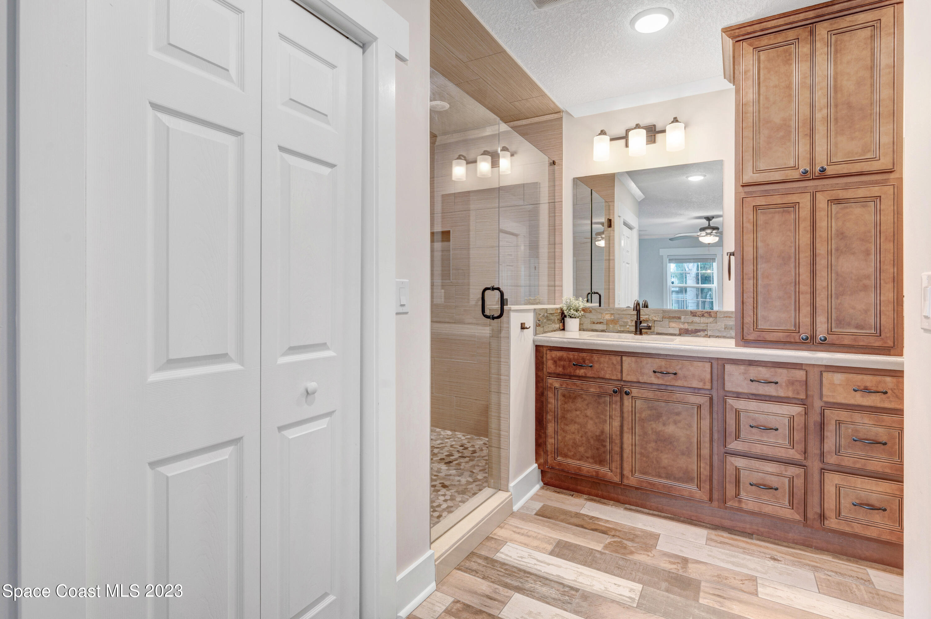 1720 Elizabeth Street Melbourne, FL 32901 - Photo 14 of 33 a spacious bathroom with a shower a sink and a mirror