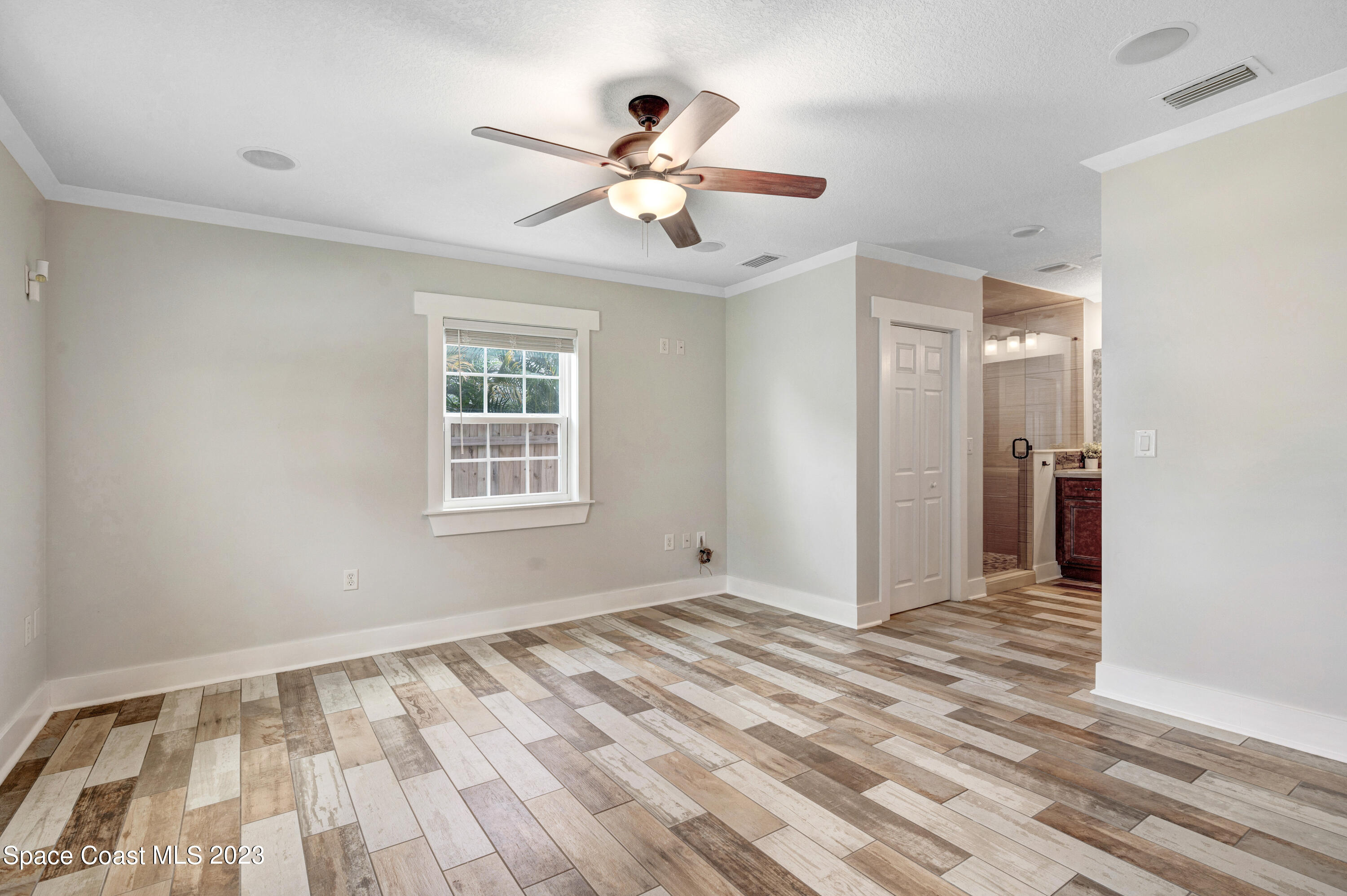1720 Elizabeth Street Melbourne, FL 32901 - Photo 15 of 33 a view of an empty room with wooden floor and a window