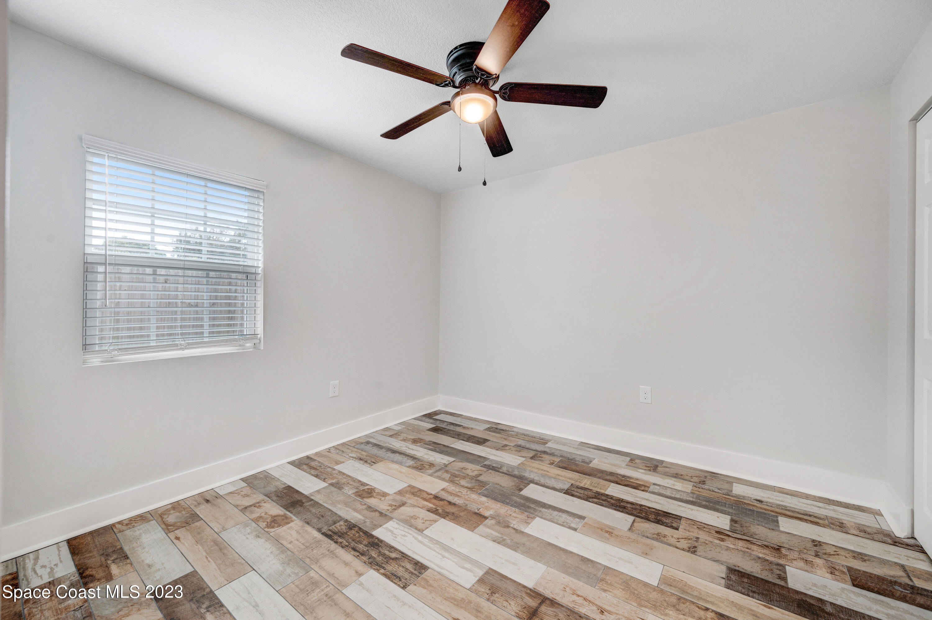 1720 Elizabeth Street Melbourne, FL 32901 - Photo 19 of 33 a view of a room with a ceiling fan and a window