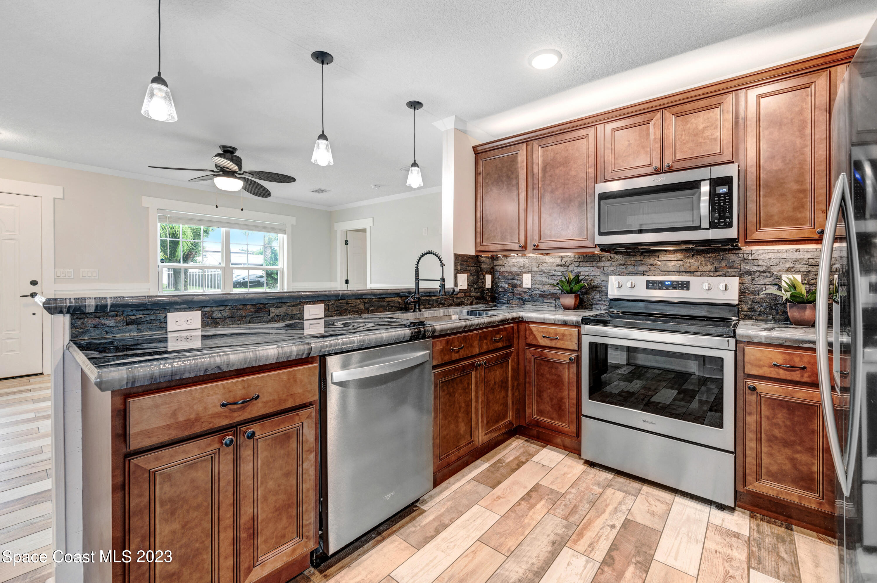 1720 Elizabeth Street Melbourne, FL 32901 - Photo 3 of 33 a kitchen with a sink stove and microwave
