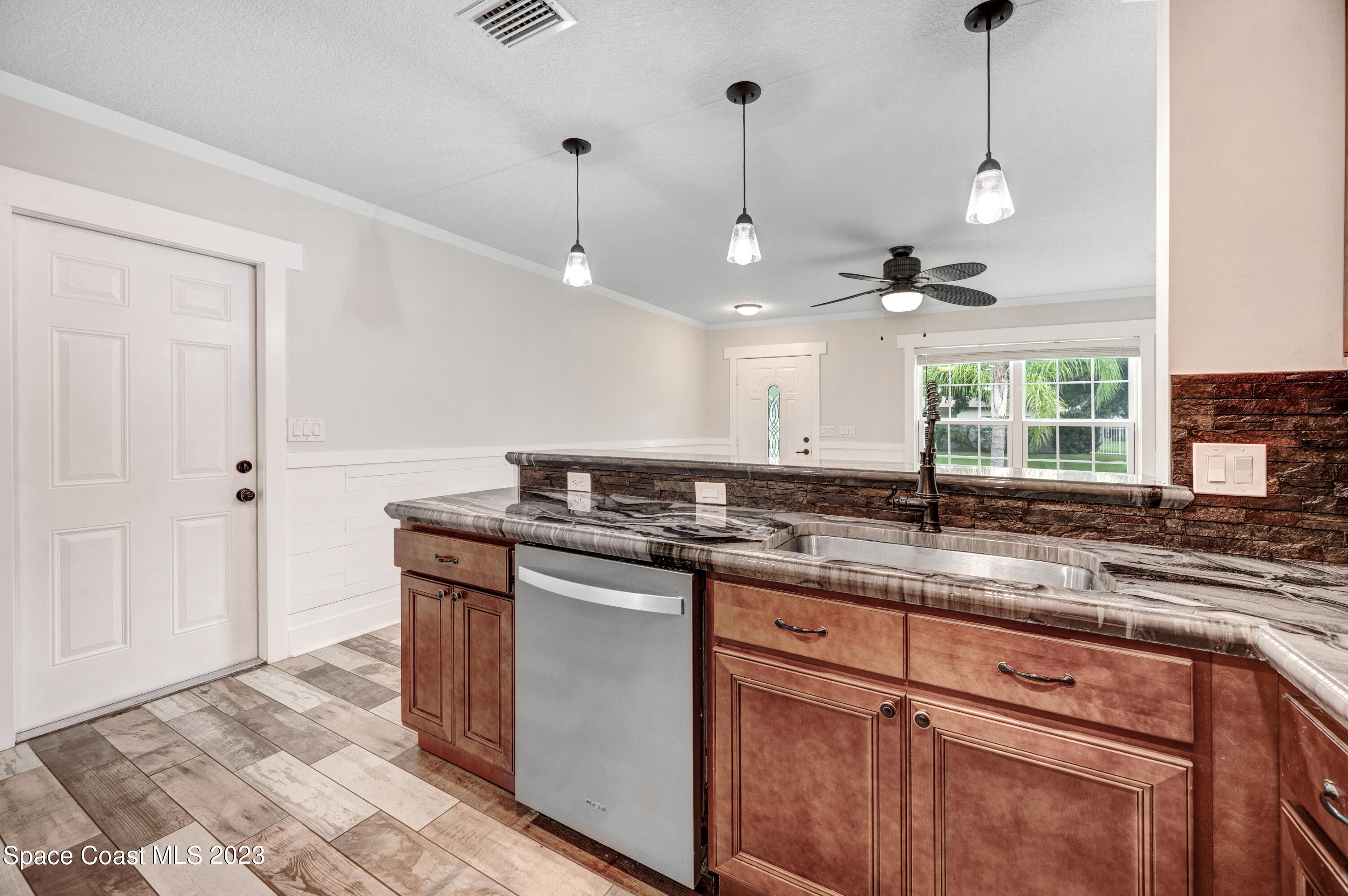 1720 Elizabeth Street Melbourne, FL 32901 - Photo 5 of 33 a kitchen with a sink a counter space appliances and cabinets