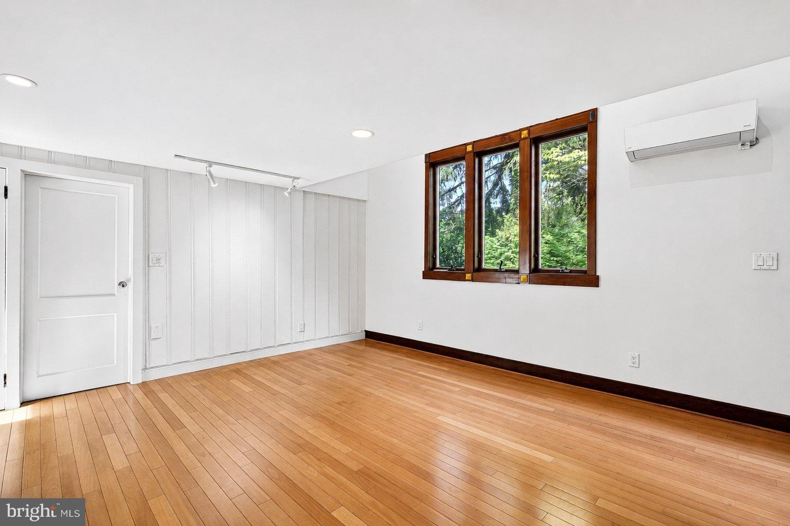 498 Perrineville Road Robbinsville, NJ 08691 - Photo 19 of 59 a view of an empty room with wooden floor and a window