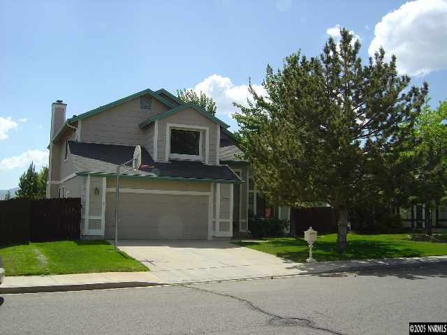 1797 Fox Run Road Reno, NV 89523 - Photo 1 of 9 a front view of a house with a yard and garage