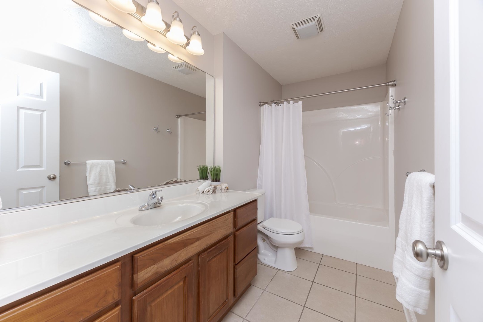 2409 Sanford Lane Normal, IL 61761 - Photo 32 of 62 a bathroom with a sink a toilet a mirror and shower