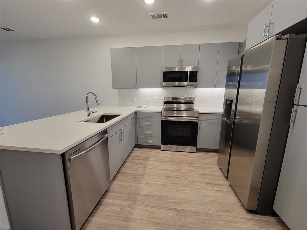 4801 Springdale Road, Unit 2211 Austin, TX 78723 - Photo 6 of 19 A contemporary kitchen features sleek cabinetry, stainless steel appliances, and a durable countertop.