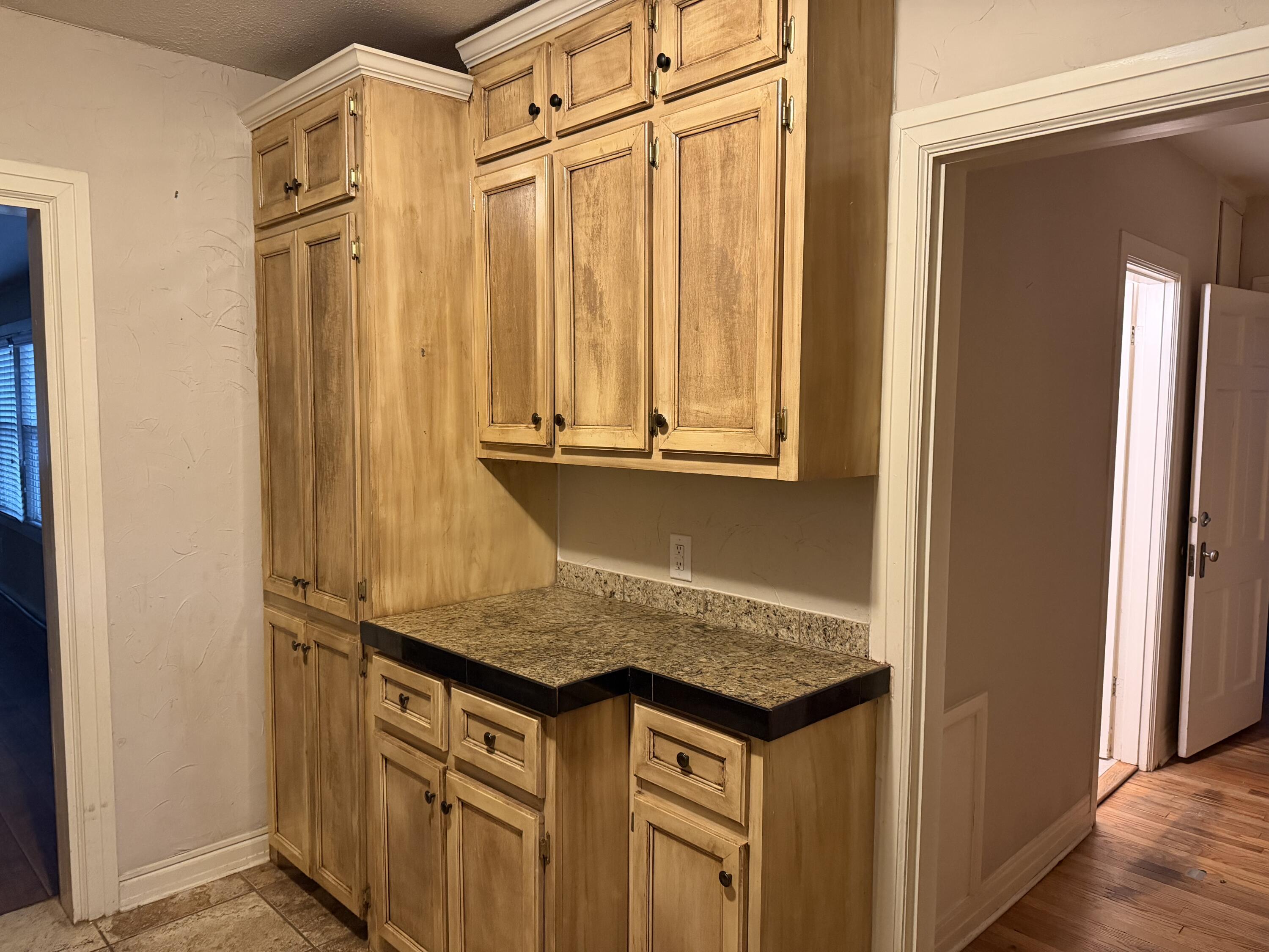 3110 22nd Street Lubbock, TX 79410 - Photo 6 of 22 a view of a kitchen cabinets and a wooden floor