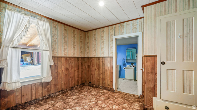 44 Shriver Street Eureka, UT 84628 - Photo 12 of 43 Room featuring wood-finish paneling, patterned wallpaper, and textured ceiling panels