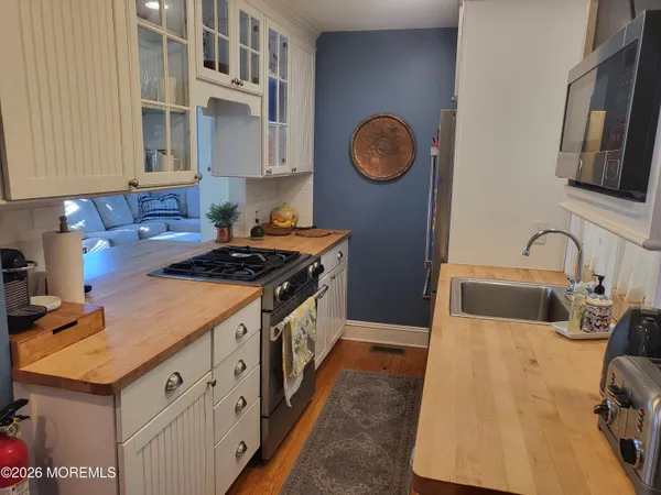 a kitchen with stainless steel appliances granite countertop a sink stove and cabinets