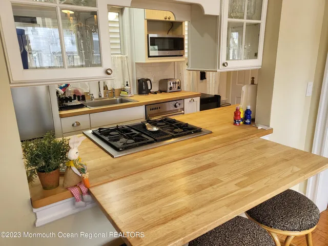 a kitchen with stainless steel appliances granite countertop a stove and a white cabinets
