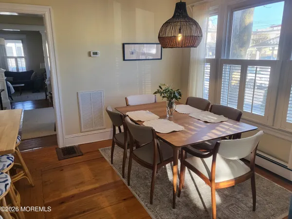 a view of a dining room with furniture and wooden floor