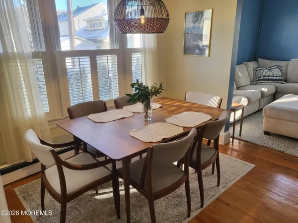 a view of a dining room with furniture and wooden floor