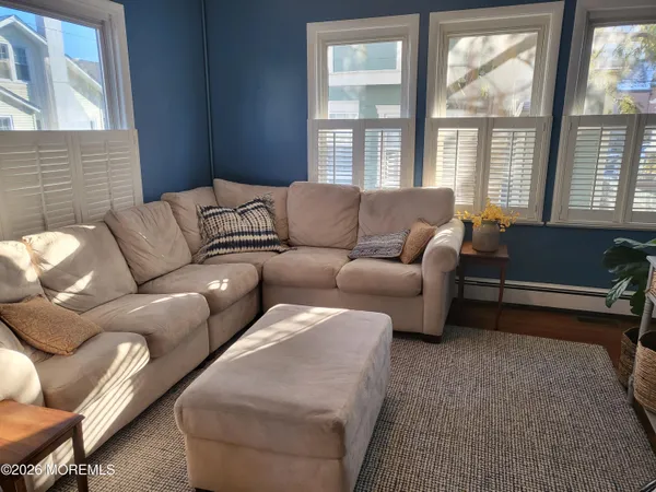 a living room with furniture and windows