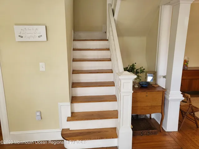 a view of entryway and hall with wooden floor