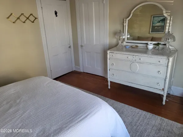 a bedroom with a bed and a dresser