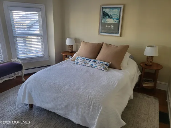 a bedroom with bed and a window